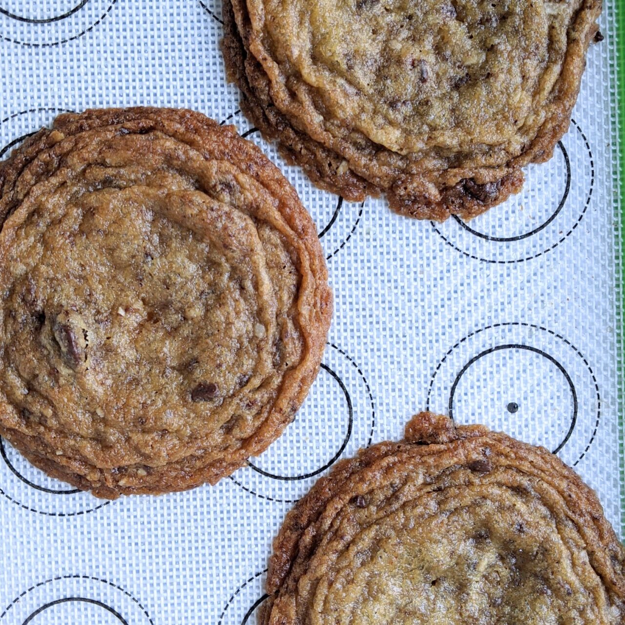 Big crinkly chocolate chip cookies on a baking sheet
